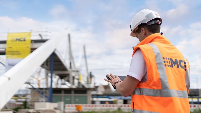 Steel plant engineer with warning vest on building site